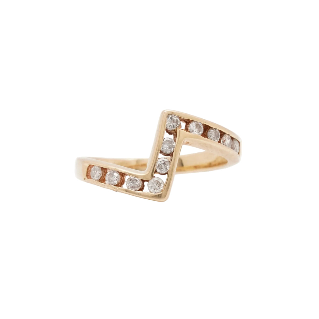 Gold ring with diamond accents on a white background