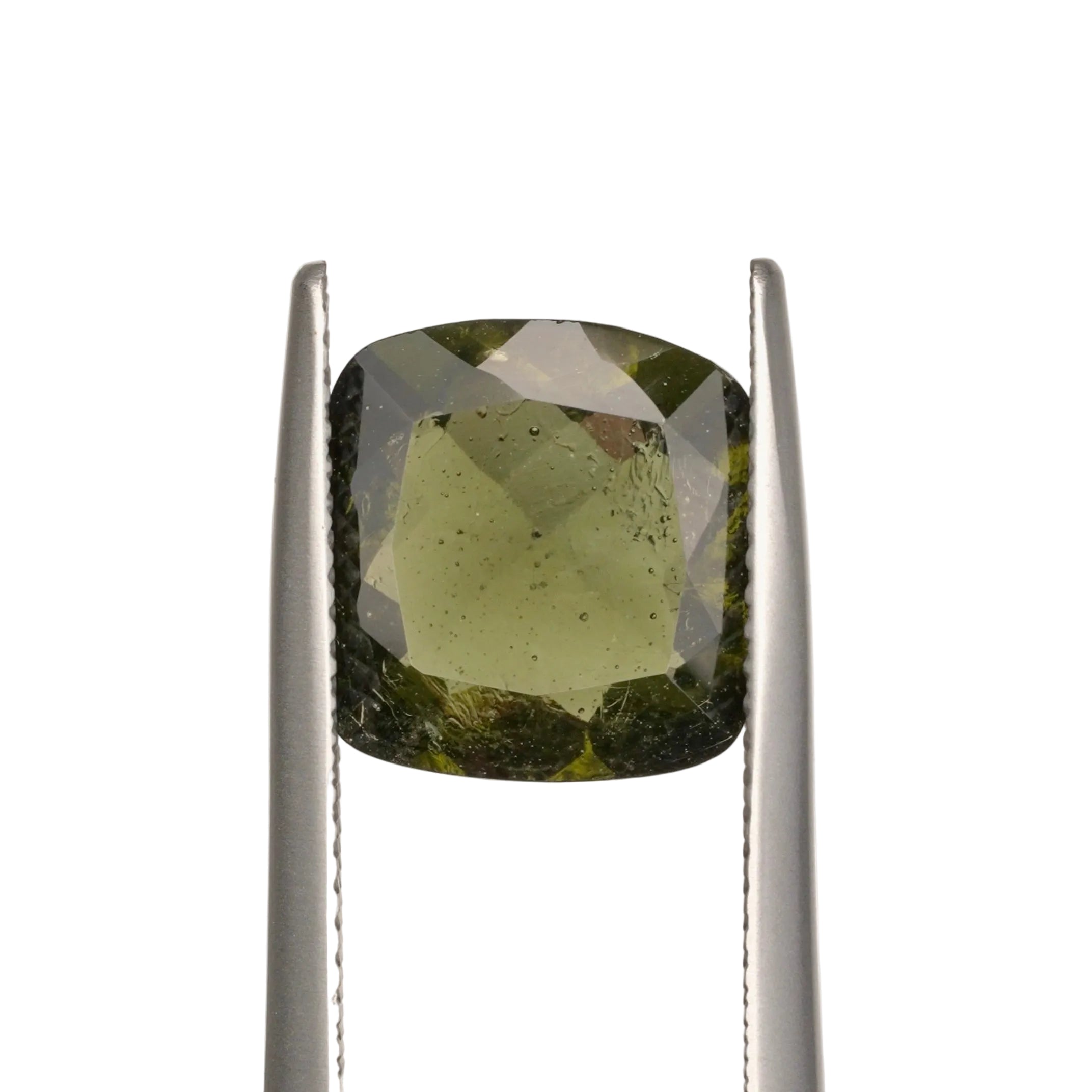 olive green moldavite gemstone in silver tweezers on a white background