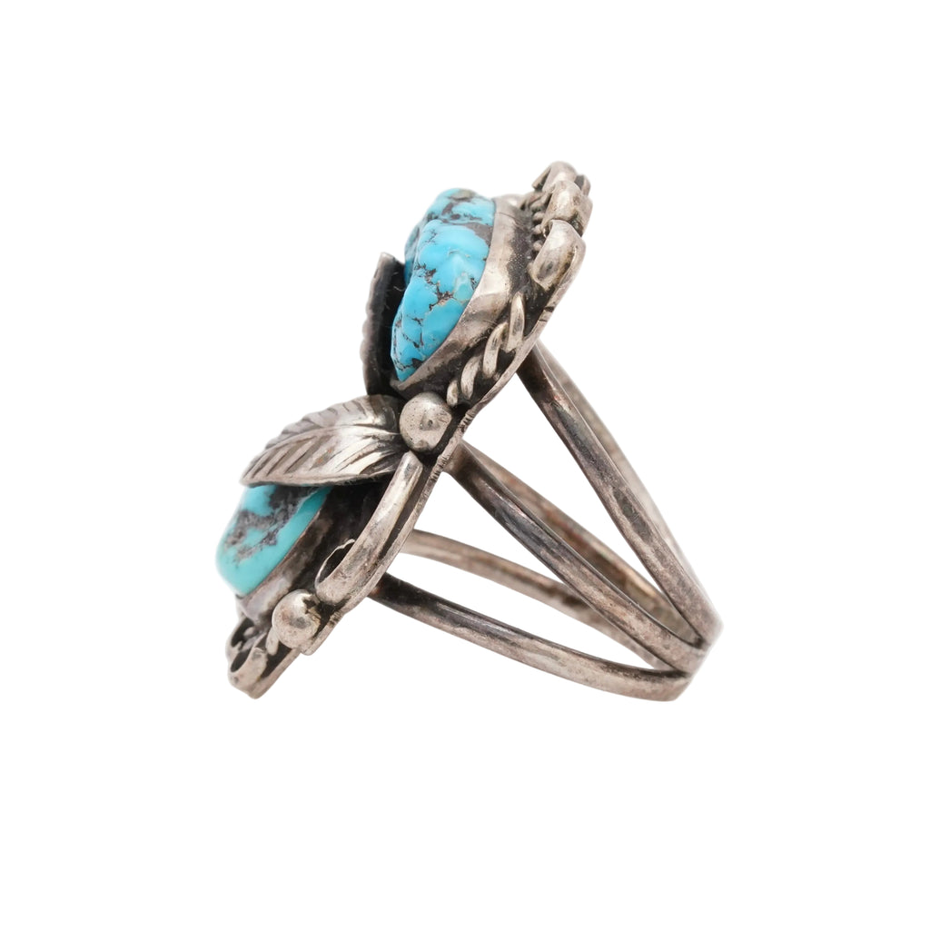 Silver ring with turquoise stones on a white background