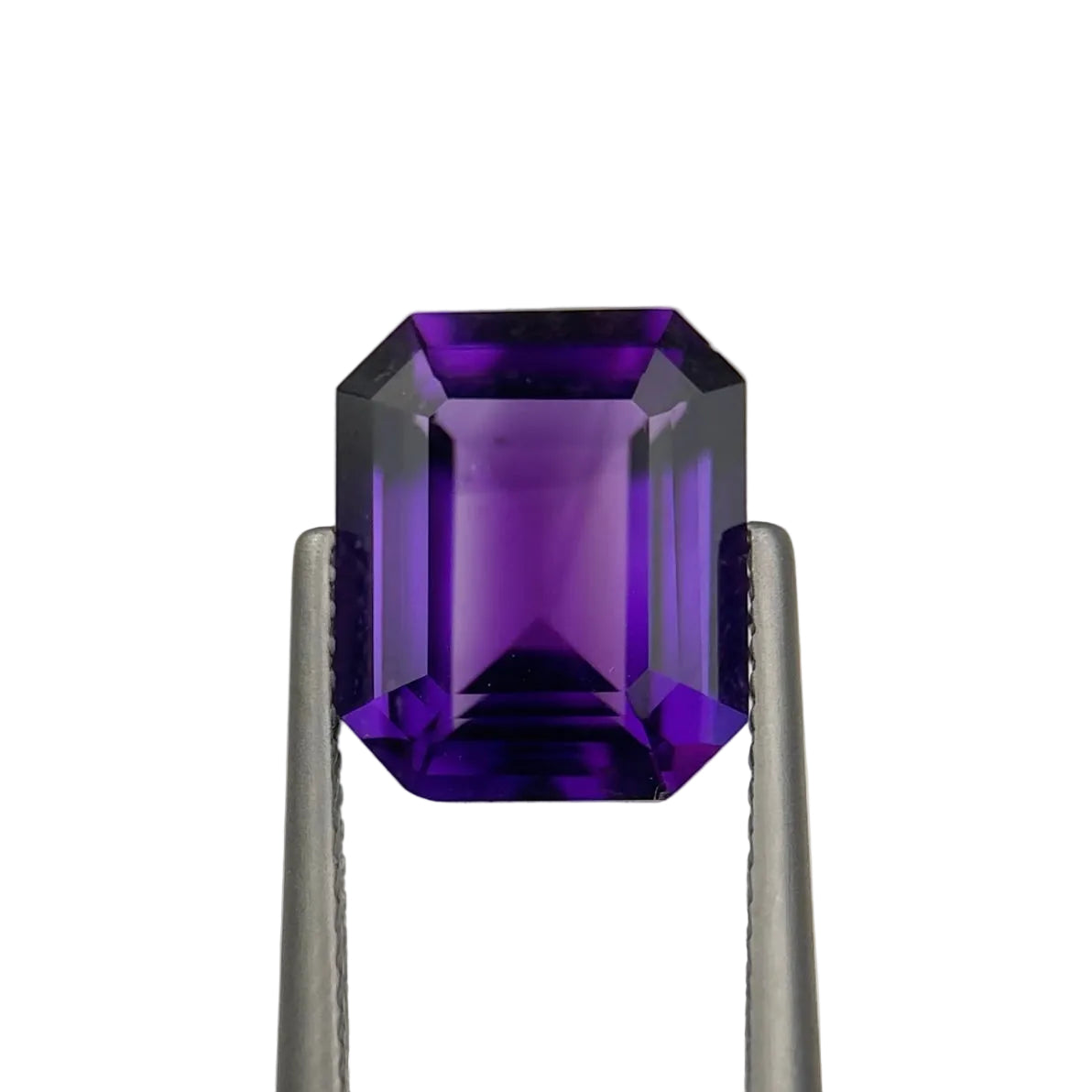 Amethyst gemstone held between tweezers on a white background