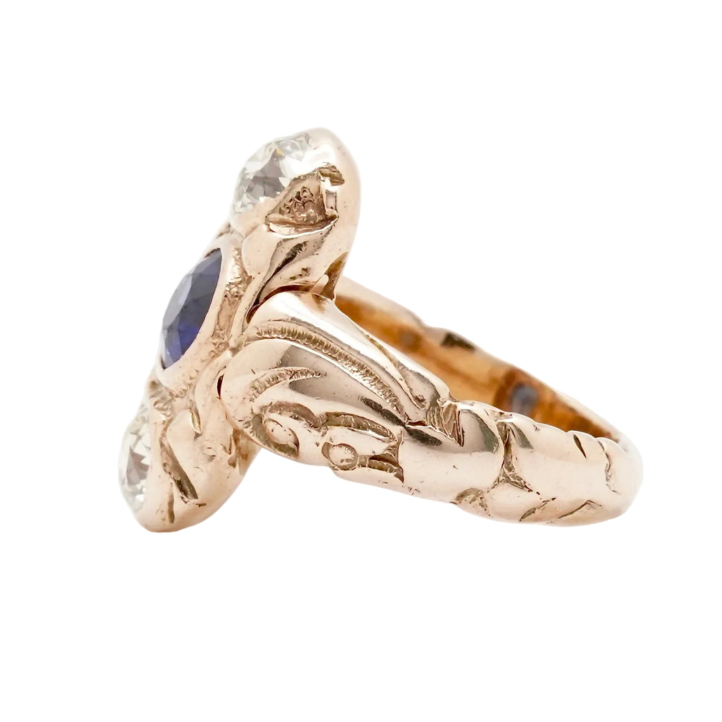 Gold ring with blue gemstone on a white background