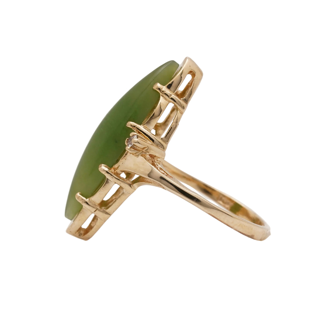 Vintage 10K gold nephrite jade ring, side view showing the tall marquise cabochon and open gallery.
