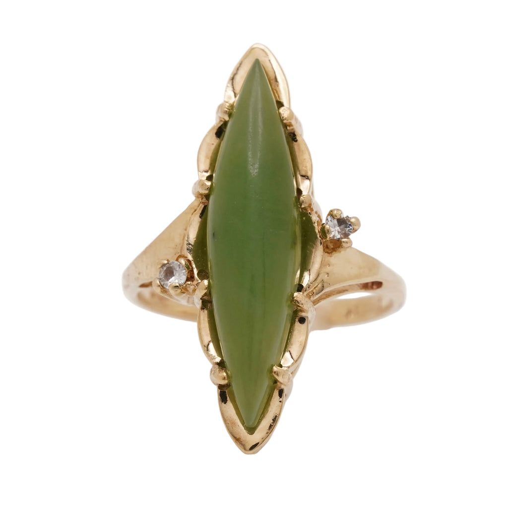 Vintage 10K gold ring with a marquise natural nephrite jade cabochon and two small colorless side stones, face-up.