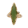 Vintage 10K gold ring with a marquise natural nephrite jade cabochon and two small colorless side stones, face-up.