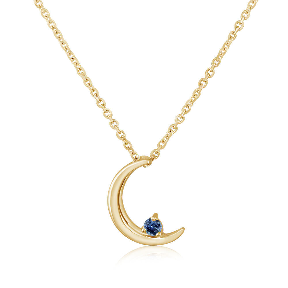 Gold crescent moon necklace with a blue gemstone on a white background