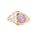 pink star sapphire in 14k yellow gold on white background
