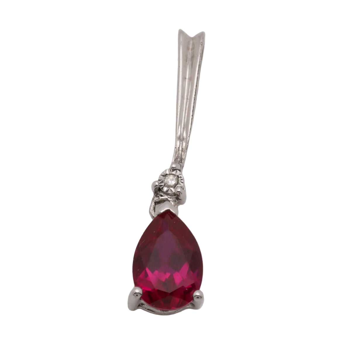 Sterling silver pendant with a pear-shaped synthetic ruby in a three-prong setting and a small round diamond at the bail, on a light grey background.