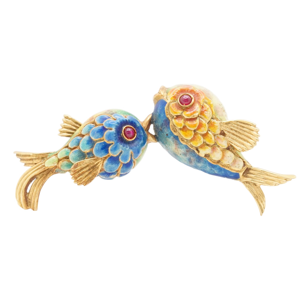 Colorful fish-shaped brooch on a white background